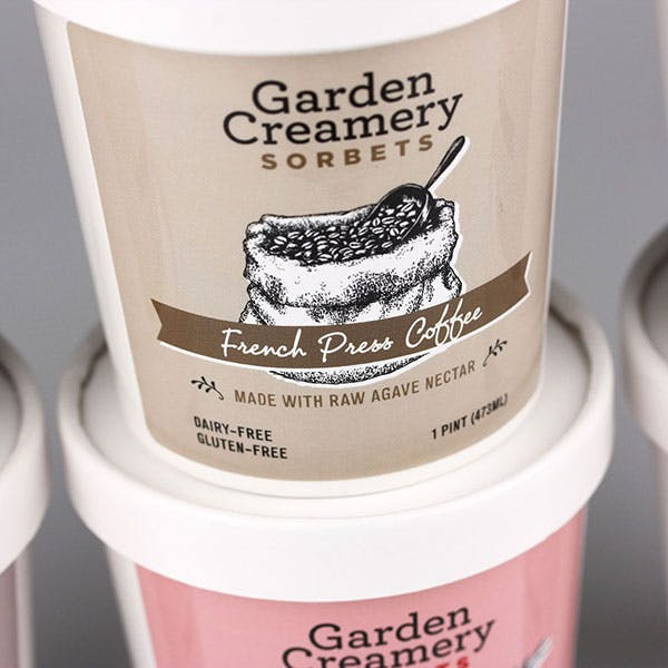 Garden Creamery Sorbets packaging in various flavours zoomed in on French Press Coffee.