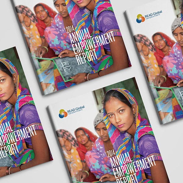 Photo of four copies of Read Global - 2014 Annual Empowerment Report